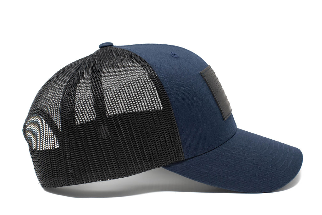 Dark blue trucker hat with black leather American flag patch