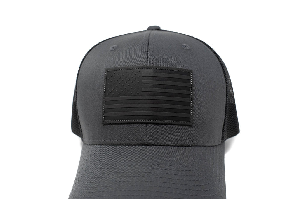 Charcoal trucker hat with black leather American flag patch