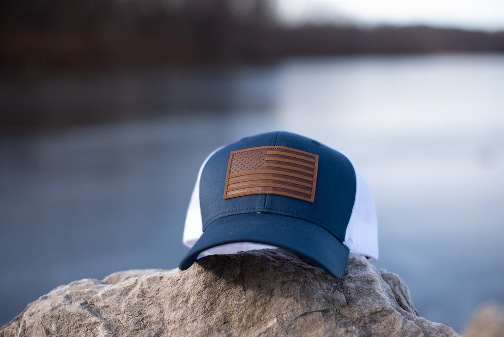 Navy trucker hat with brown leather American flag patch