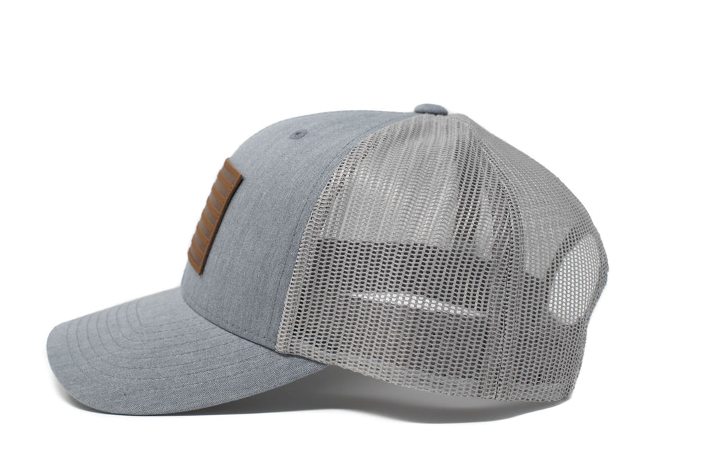 Grey trucker hat with brown leather American flag patch